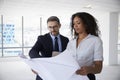 Businesspeople Meeting To Look At Plans In Empty Office Royalty Free Stock Photo