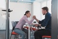 Businesspeople, rivalry and people concept - businesswoman and businessman arm wrestling during corporate meeting in Royalty Free Stock Photo