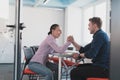 businesspeople, rivalry and people concept - businesswoman and businessman arm wrestling during corporate meeting in Royalty Free Stock Photo