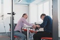 Businesspeople, rivalry and people concept - businesswoman and businessman arm wrestling during corporate meeting in Royalty Free Stock Photo