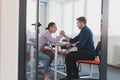 Businesspeople, rivalry and people concept - businesswoman and businessman arm wrestling during corporate meeting in Royalty Free Stock Photo