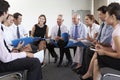 Businesspeople Seated In Circle At Company Seminar Royalty Free Stock Photo