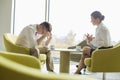 Businesspeople in serious discussion at office lobby Royalty Free Stock Photo