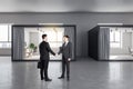 Businesspeople shaking hand in office interior Royalty Free Stock Photo