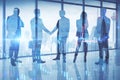 Businesspeople shaking hands in modern blue office interior with panoramic city view and forex chart. Teamwork, market and success Royalty Free Stock Photo