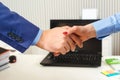 Businesspeople shaking hands at office. Man and woman concluding business deal. Business meeting. Business partner, company