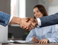 Businesspeople Shaking Hands in Office Setting for Partnership Agreement Royalty Free Stock Photo