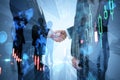 Businesspeople shaking hands working together on abstract city background with forex chart. Teamwork, trade, finance and Royalty Free Stock Photo