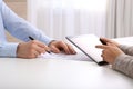 Businesspeople signing contract at white table in office, closeup of hands Royalty Free Stock Photo