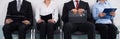 Businesspeople Sitting On Chair Waiting For Interview