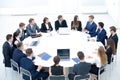 Businesspeople Sitting At Conference Round Table At The Meeting