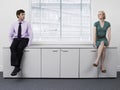 Businesspeople Sitting On Office Cabinets Royalty Free Stock Photo