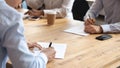 Businesspeople sitting at table during meeting reached agreement signing contract