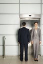 Businesspeople Standing In Front Of Elevator Royalty Free Stock Photo