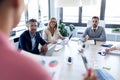 Businesspeople taking notes with laptop and paying attention in conference on coworking place Royalty Free Stock Photo