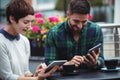 Businesspeople using digital tablet while having coffee Royalty Free Stock Photo