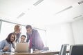 Businesspeople using laptop at conference table Royalty Free Stock Photo