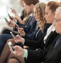 Businesspeople Using Technology In Busy Lobby Area Of Office Royalty Free Stock Photo