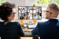 Businesspeople Video Conferencing With Their Partner On Computer