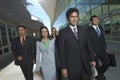 Businesspeople Walking Past Office Building Royalty Free Stock Photo