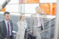 Businesspeople walking up stairs in train station