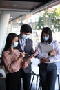 Businesspeople wearing protective mask using digital tablet and discussing strategy for business. Royalty Free Stock Photo