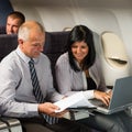 Businesspeople working on computer flight airplane