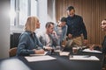 Businesspeople working on a laptop during a boardroom meeting Royalty Free Stock Photo