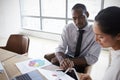 Businesspeople Working On Laptop In Boardroom Together Royalty Free Stock Photo