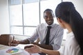 Businesspeople Working On Laptop In Boardroom Together Royalty Free Stock Photo