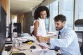 Businesspeople Working At Office Desk On Computer Together Royalty Free Stock Photo