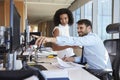 Businesspeople Working At Office Desk On Computer Together Royalty Free Stock Photo