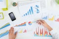 Businessperson Analyzing Graphs At Desk