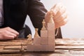 Businessperson Arranging Chess Piece On Wooden Blocks