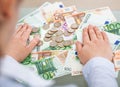 Businessperson With Banknotes And Coins