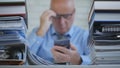 Businessperson In Blurred Image Reading Mobile Phone Online Message Royalty Free Stock Photo