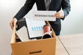 Businessperson carrying packing personal company on brown cardboard Box and resignation letters for quit or change of job leaving Royalty Free Stock Photo