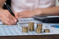 Businessperson With Coins Over Graph And Report Royalty Free Stock Photo