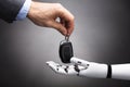 Businessperson Giving Car Key To Robot