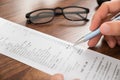 Businessperson hands with receipt and eyeglasses