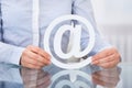 Businessperson Holding Email Sign At Workplace