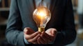 Businessperson holding light bulb, brainstorming idea generation photo