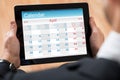 Businessperson Looking At Calendar On Digital Tablet