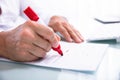 Businessperson Marking Error With Marker On Document