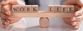 Businessperson Protecting Life And Work On Wooden Seesaw Royalty Free Stock Photo