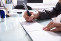 Businessperson Signing Cheque In Office Royalty Free Stock Photo