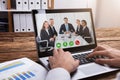 Businessperson Video Conferencing With Colleagues On Laptop Royalty Free Stock Photo