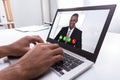 Businessperson Video Conferencing With Male Colleague On Laptop