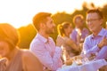 Businesss colleagues standing while talking on table at rooftop