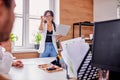 Handsome asian woman in glasses holding laptop while talking for group of people